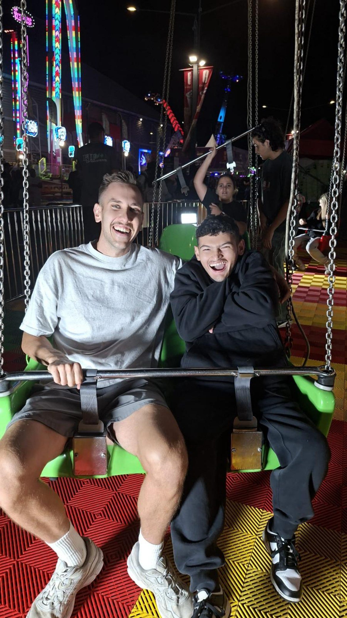 Support worker and participant enjoying a night out at a community event
