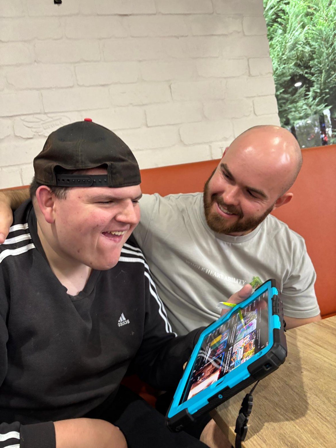 Support worker and participant looking through photos together