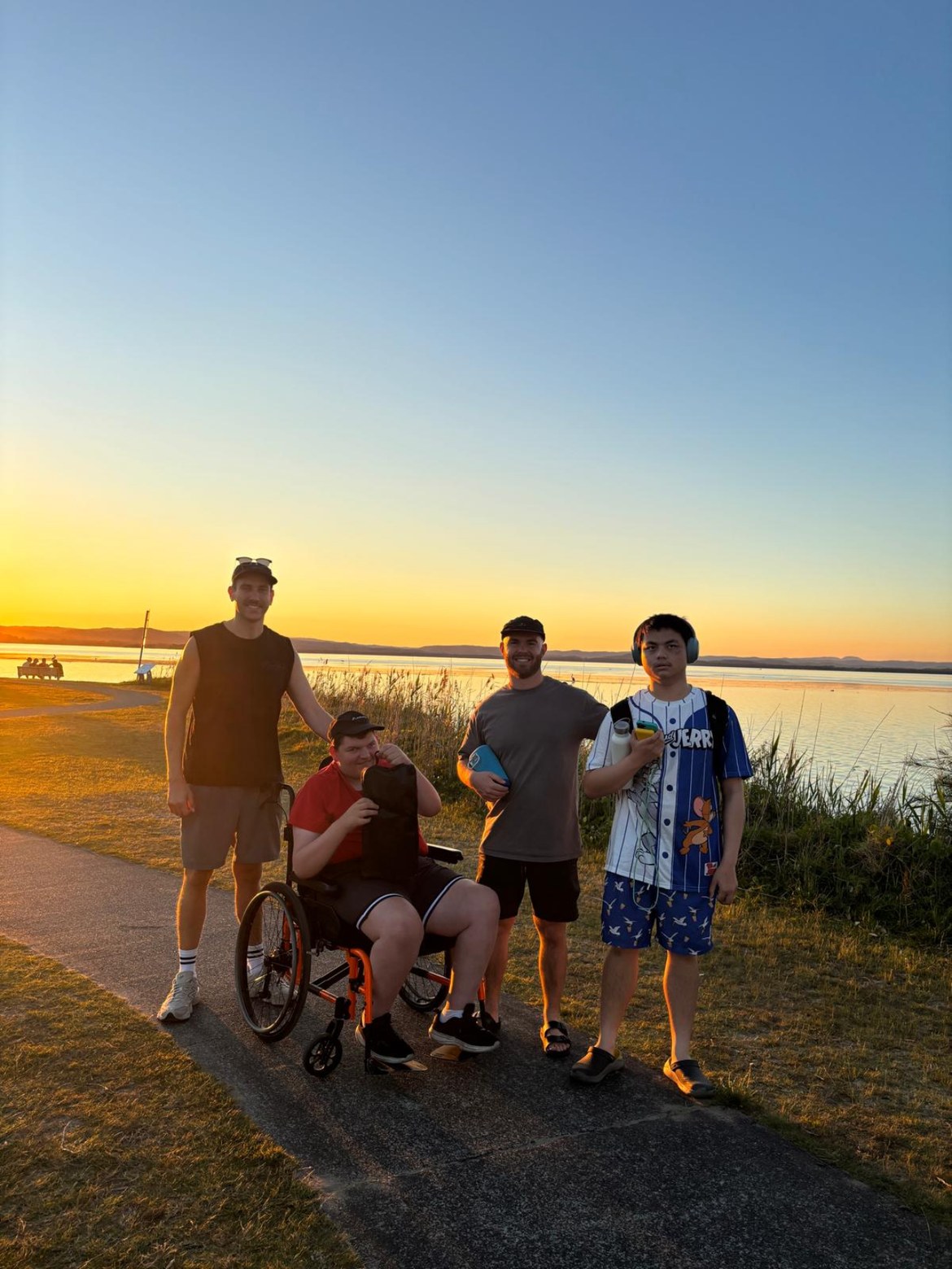 Participants and support workers watching the sunset together